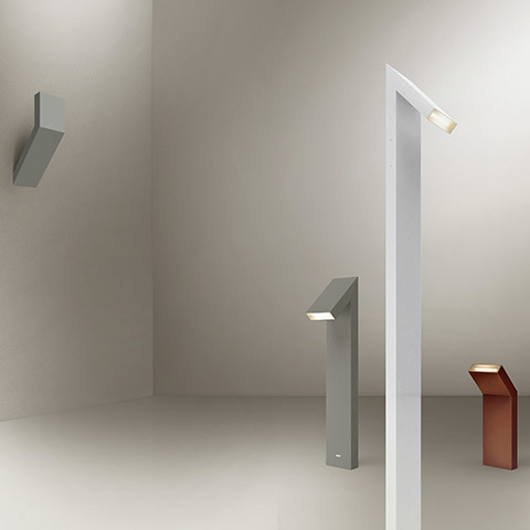 Famiglia Chilone: lampade LED geometriche in grigio e rame, nelle versioni applique, paletto da terra e lampada da terra alta