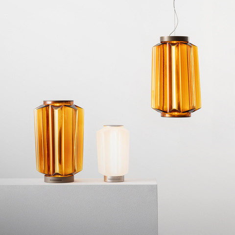 Artemide Auralia lamps: two amber ribbed glass table lamps and one matching pendant, plus a small white opal table lamp