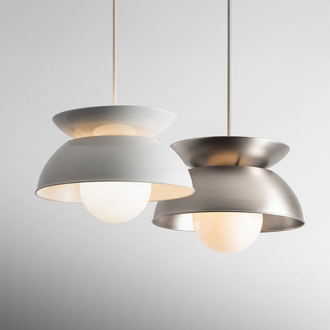 Two Artemide Cetra pendant lamps: white matte and brushed nickel finishes, each with a double-disc shade and opal glass globe bulb