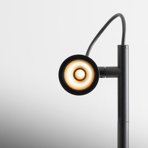 Artemide Conus floor lamp in matte black, circular LED head with concentric light rings on adjustable arm and vertical pole
