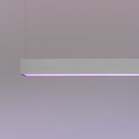 Artemide A.39 INTEGRALIS pendant lamp: sleek white linear suspension emitting a vibrant purple-pink light along its bottom edge