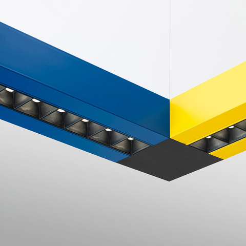 Artemide Katà Métron modular linear LED lighting system with blue and yellow profiles meeting at a black corner junction