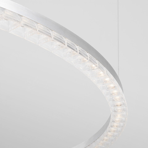 Close-up of Artemide Somnium circular pendant lamp with polished aluminum ring and crystal glass LED modules
