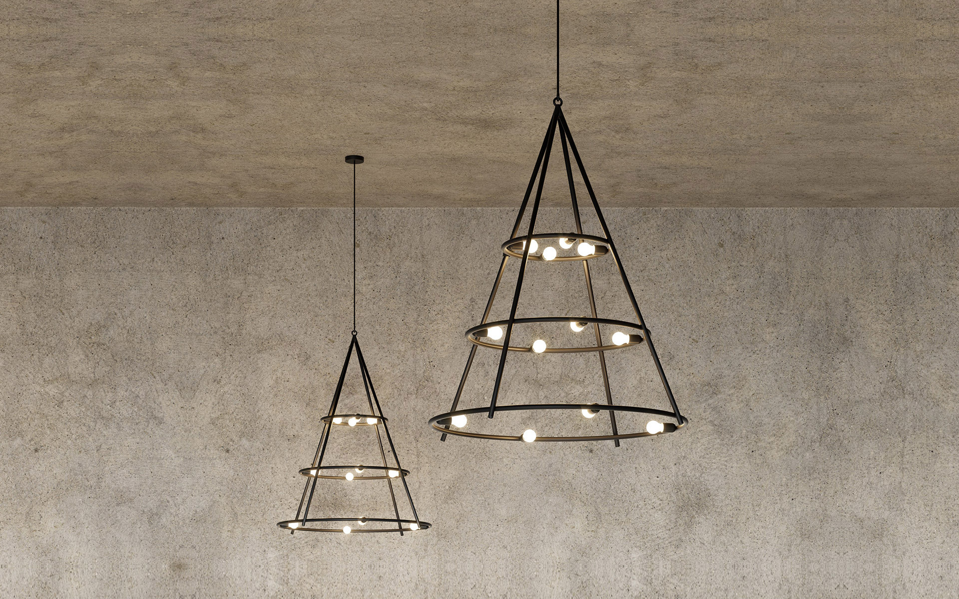 Due lampade a sospensione coniche in metallo scuro con anelli a livelli che reggono piccole lampadine sferiche, appese al soffitto su parete in cemento