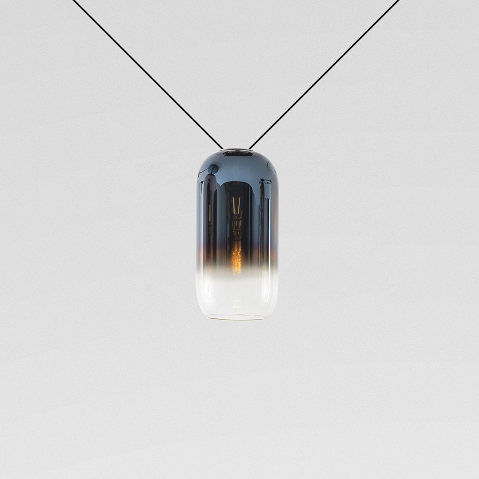 Artemide Gople Mini pendant lamp: capsule-shaped blown glass shade with dark blue-to-clear gradient, suspended on black cable