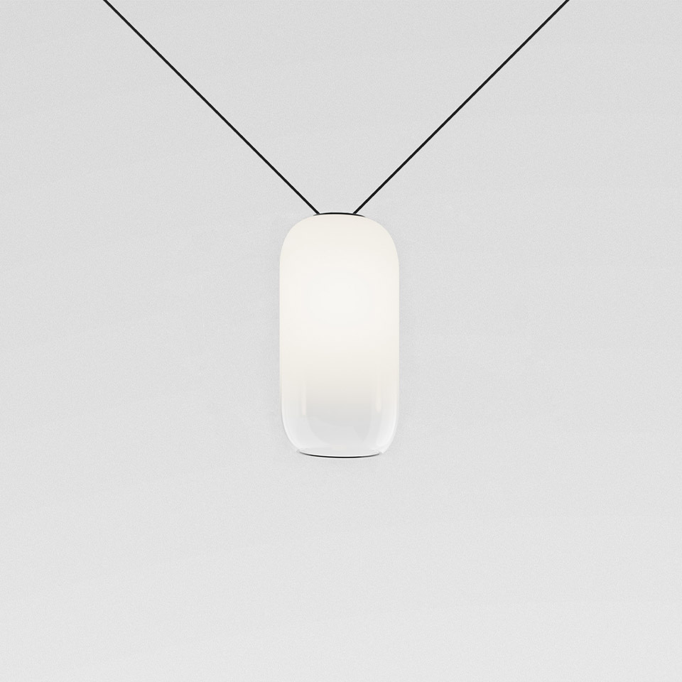 Artemide Funivia pendant lamp: oval frosted white glass diffuser suspended on a diagonal black cable system