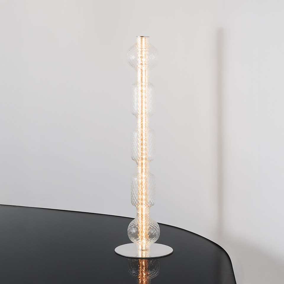 Artemide Alambicco table lamp: tall vertical column of stacked clear glass spheres with central LED strip on white circular base