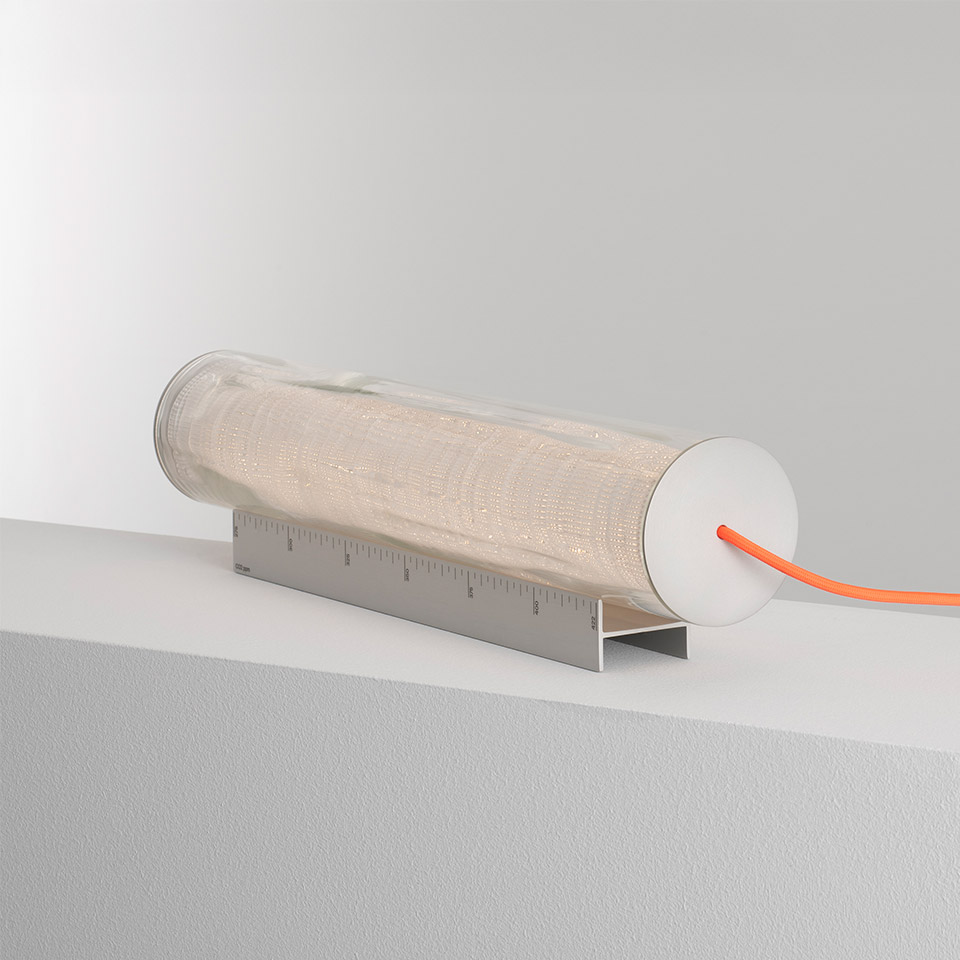 Artemide Criosfera table lamp: horizontal cylindrical glass diffuser on a ruler-shaped metal base with an orange power cord