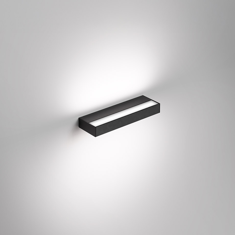 Artemide Hoy Parete wall lamp: rectangular black body with central diffuser emitting upward and downward light on wall