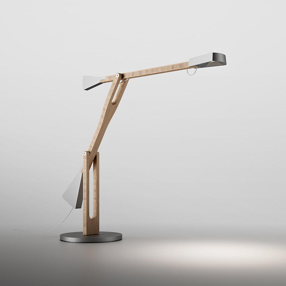Artemide Internode desk lamp with articulated natural wood arm, dark metal head and base, providing focused directional light