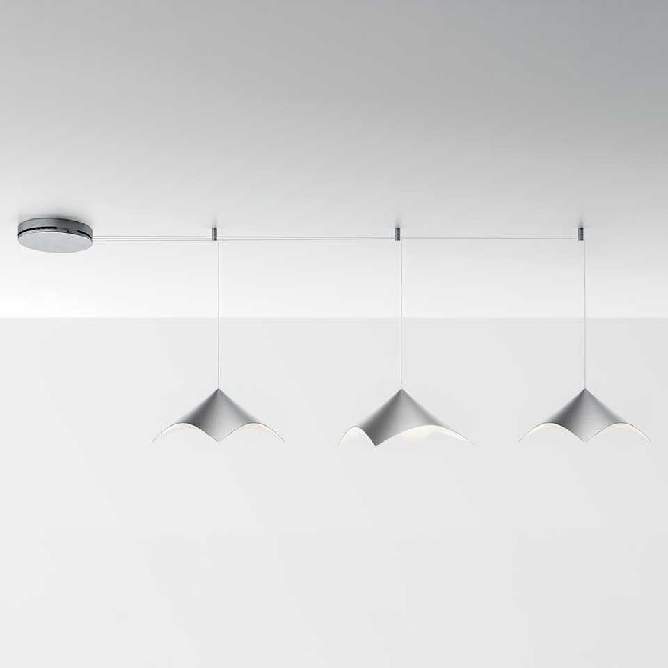 Artemide Iperbole suspension system: three white conical pendant lights hanging from a horizontal ceiling rail with chrome canopy.