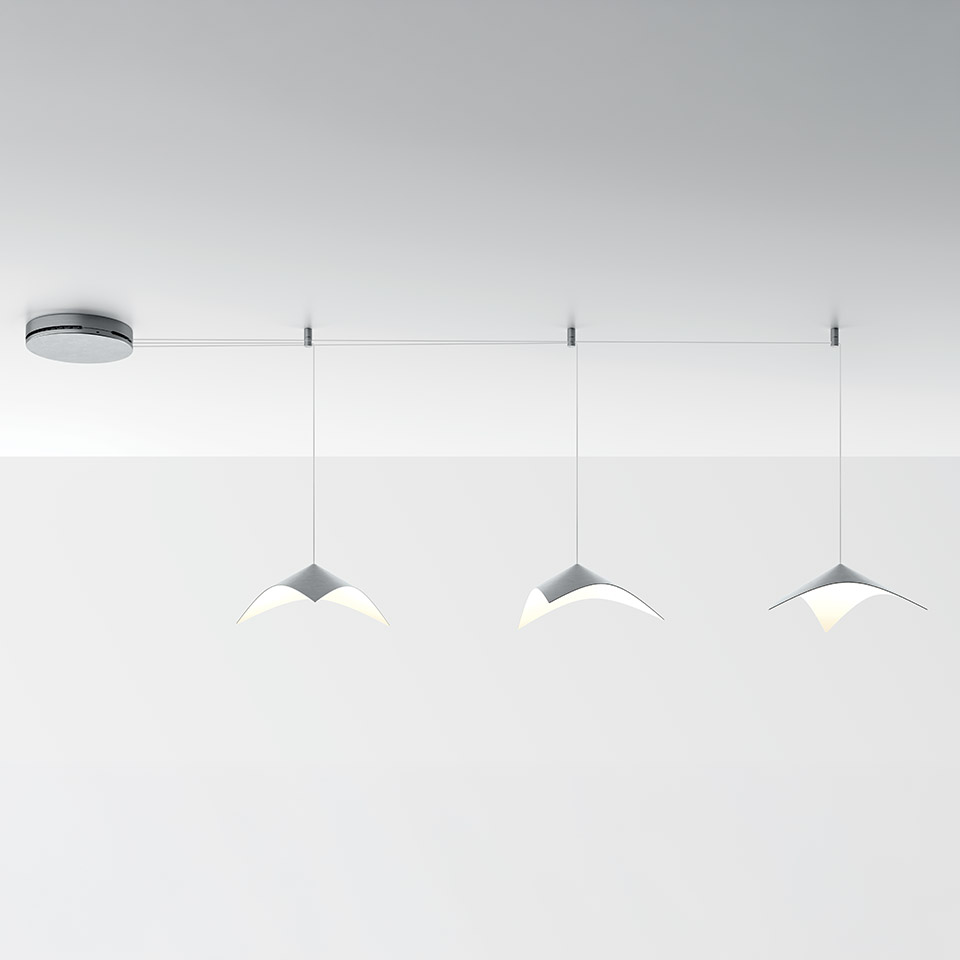 Artemide Iperbole suspension system: three white bird-wing shaped LED pendants hanging from a horizontal ceiling rail