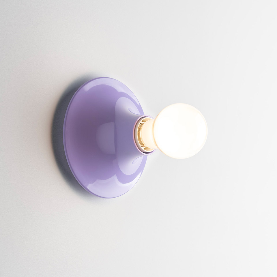 Artemide Teti wall lamp with lavender glossy dome-shaped base and exposed spherical frosted bulb mounted on white wall