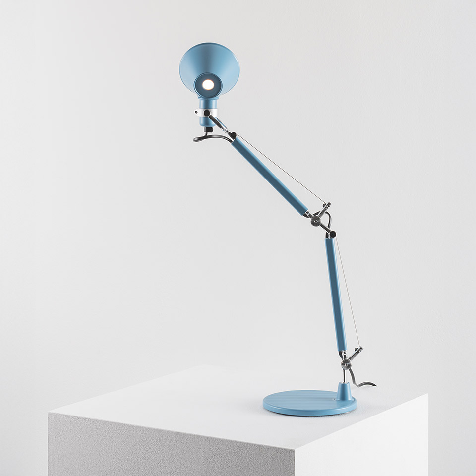 Artemide Tolomeo Micro Tavolo desk lamp in light blue, featuring articulated double-arm, circular reflector shade, and round base