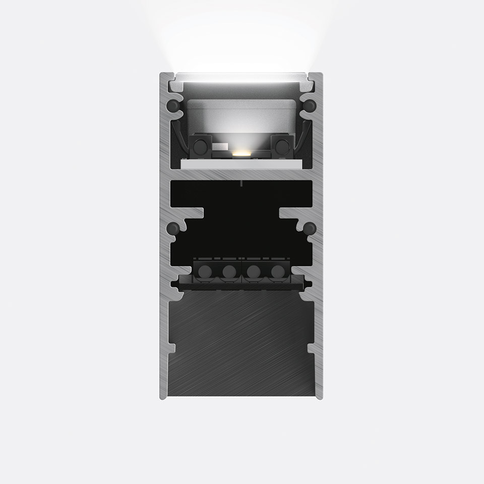 Sezione trasversale del sistema Binario Magnetico Artemide A.24 con profilo in alluminio, sorgente LED con luce bianca verso l'alto e componenti del connettore magnetico