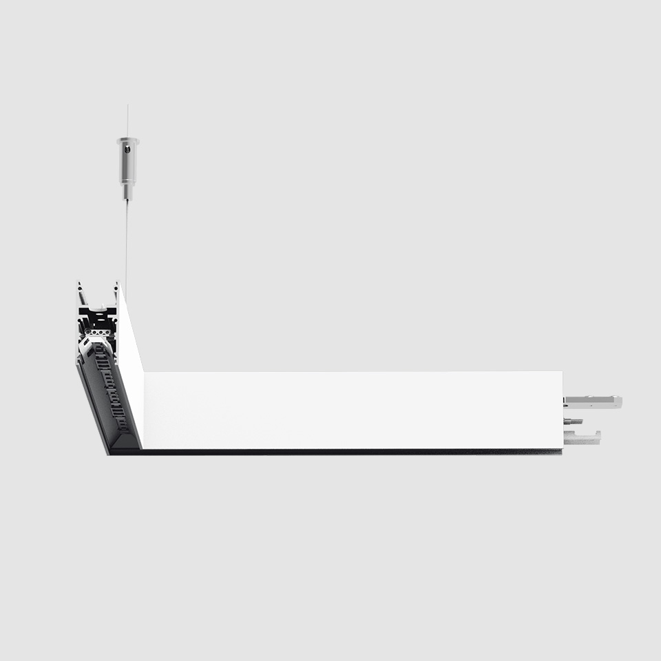 Apparecchio LED lineare da incasso Artemide A.24 Emissione Diffusa in bianco, mostrato sospeso con cavo in acciaio e connettore modulare