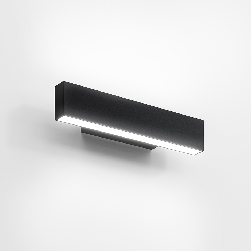Artemide A.24 Parete wall lamp, matte black rectangular LED fixture emitting diffused light downward from white opal diffuser
