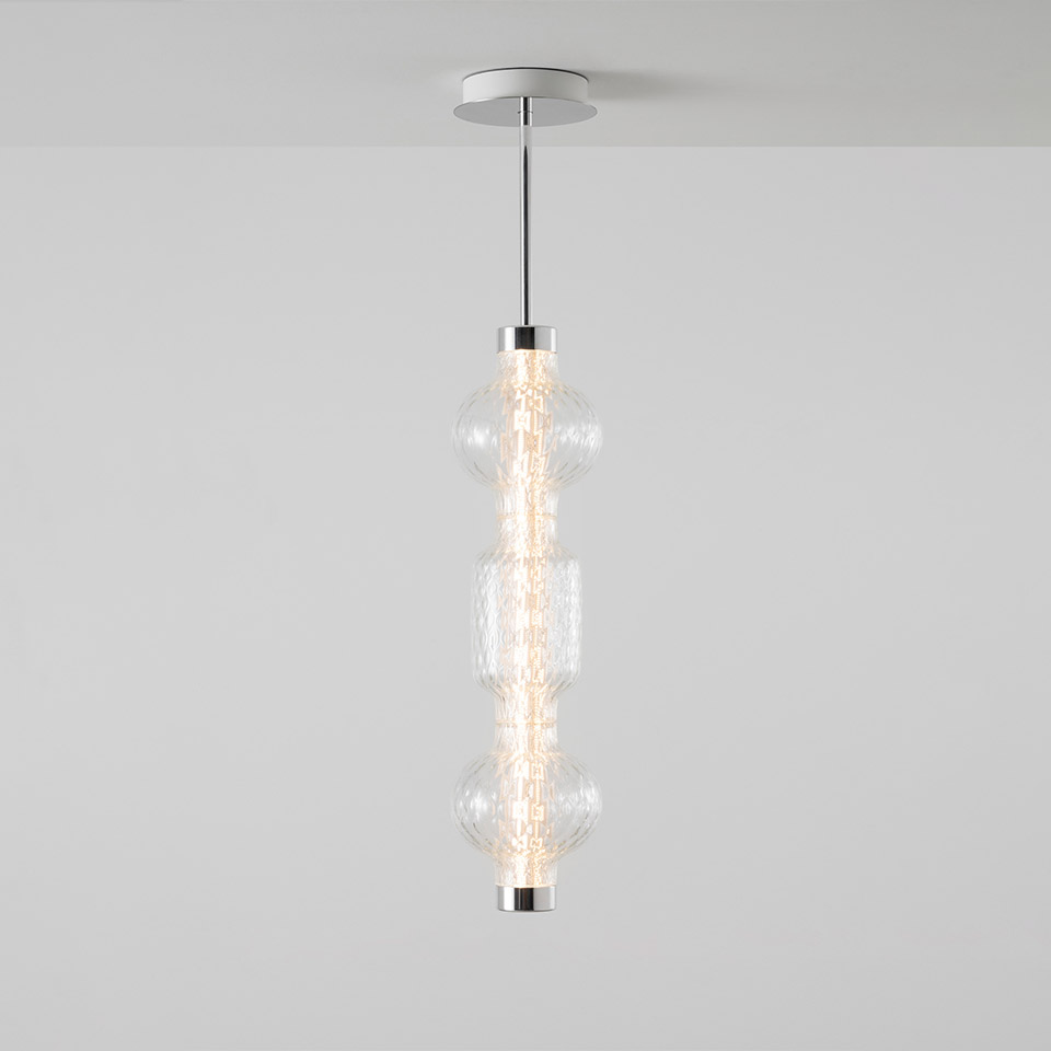 Artemide Alambicco pendant lamp: vertical chrome rod with three stacked clear glass globes emitting warm LED light