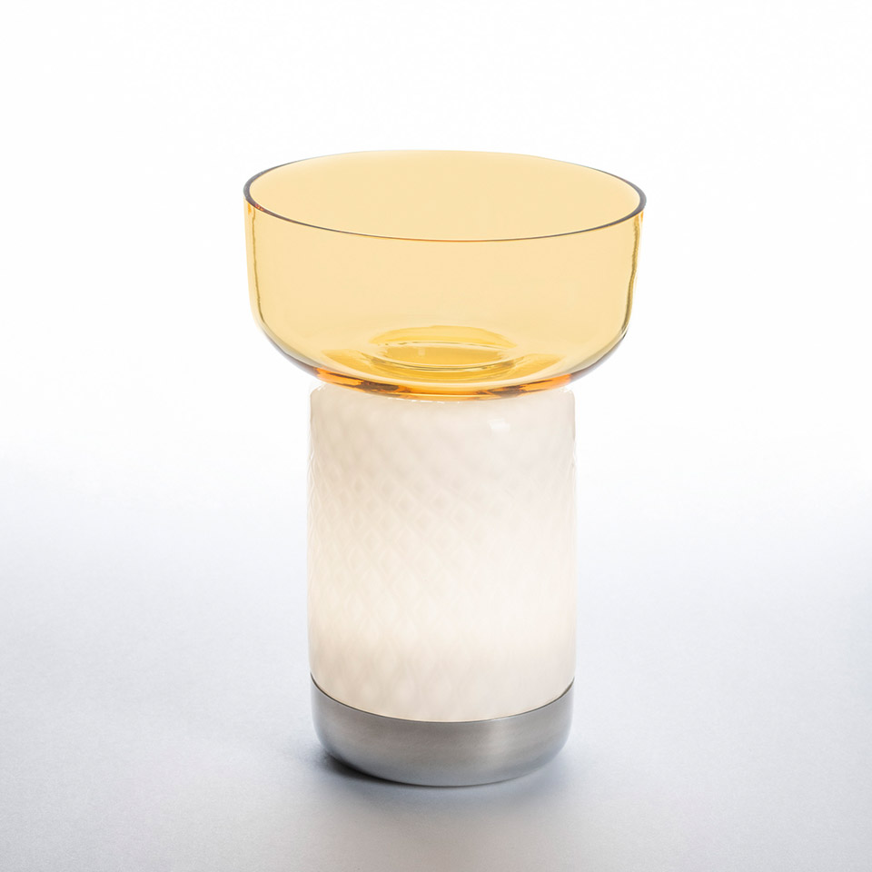 Artemide Bontà table lamp: cylindrical white textured glass body on metal base, topped with amber transparent bowl-shaped diffuser