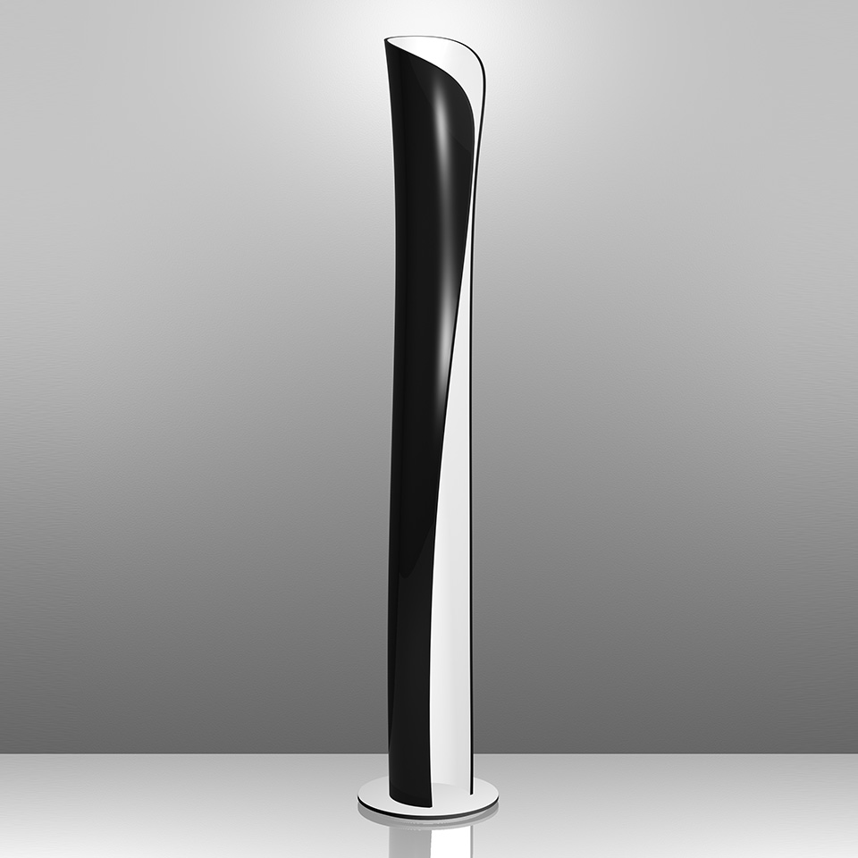 Artemide Cadmo floor lamp: tall slender twisted column in black and white, emitting indirect upward light from its curved opening