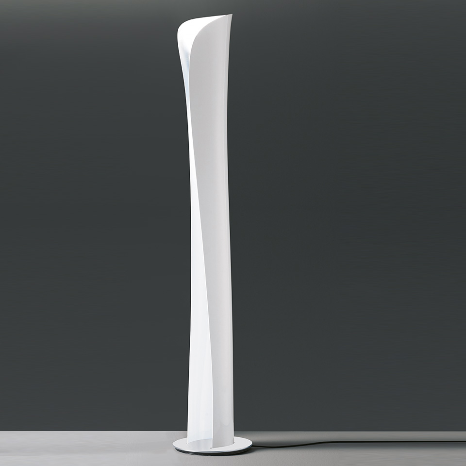 Artemide Cadmo floor lamp: tall slender twisted white column diffuser on a round base, emitting soft indirect light