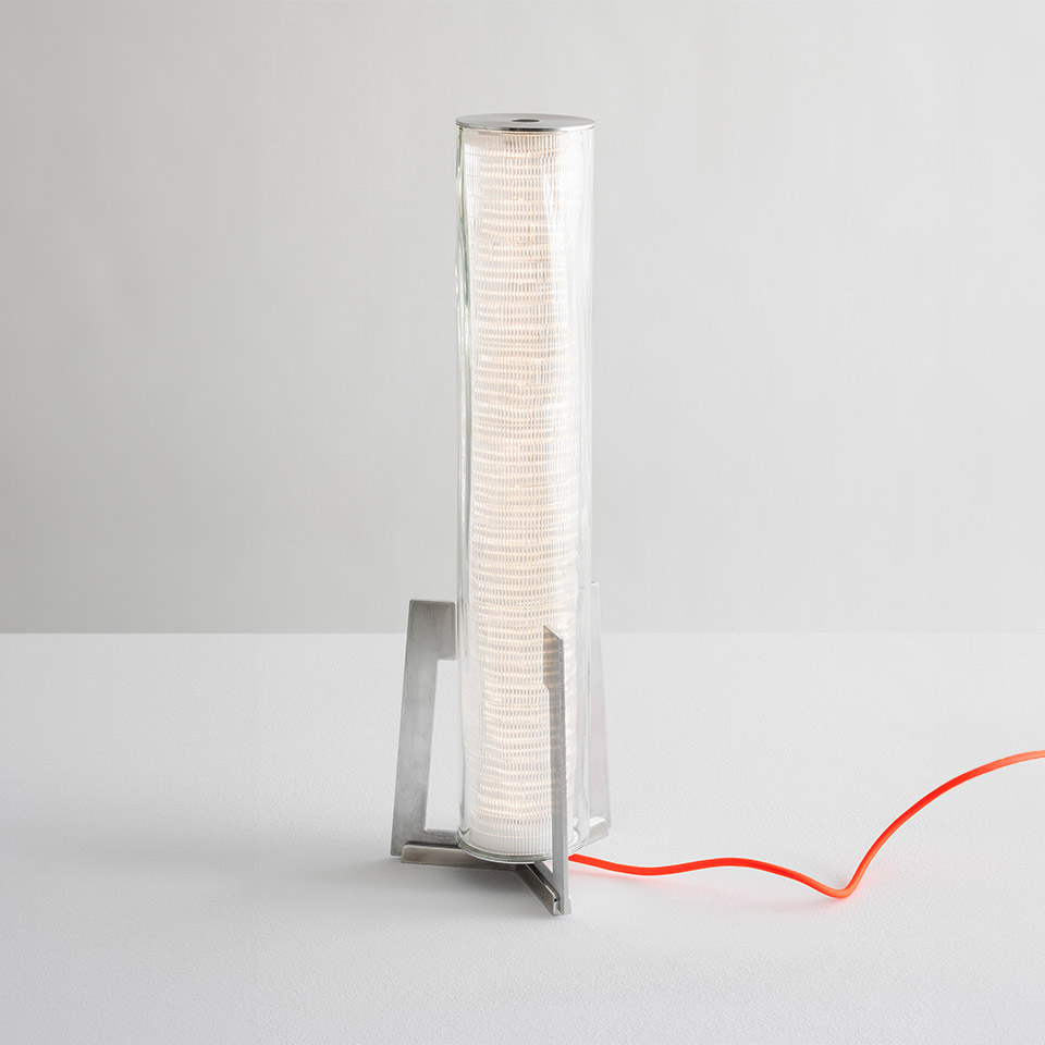Artemide Criosfera table lamp: cylindrical clear glass diffuser with ribbed white inner shade on metal base and orange power cord