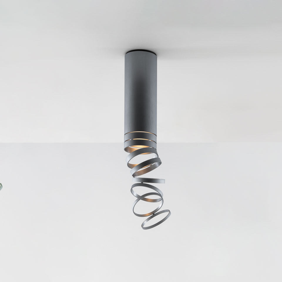 Artemide Decomposé Light Soffitto: grey ceiling lamp with cylindrical body and decorative spiral metal ribbon diffuser