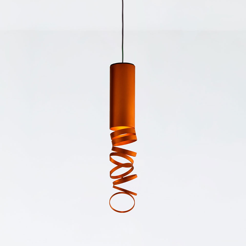 Artemide Decomposé Light pendant lamp in orange, featuring a cylindrical body with a spiraling ribbon shade on a black cord