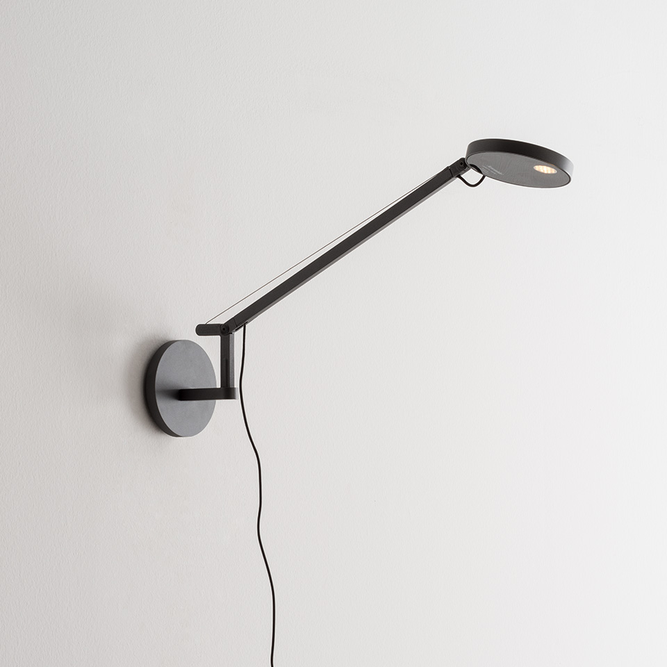 Artemide Demetra Micro Parete wall lamp in anthracite, featuring an adjustable arm and circular LED head mounted on a round wall base
