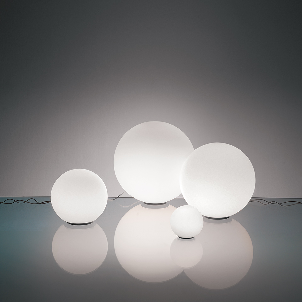 Quattro lampade da tavolo Artemide Dioscuri in diverse dimensioni, con diffusori sferici in vetro bianco satinato su superficie riflettente
