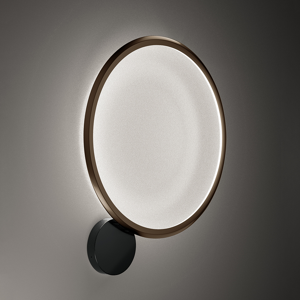 Artemide Discovery Parete wall lamp: large circular LED diffuser with bronze ring, emitting soft white light, mounted via black circular bracket