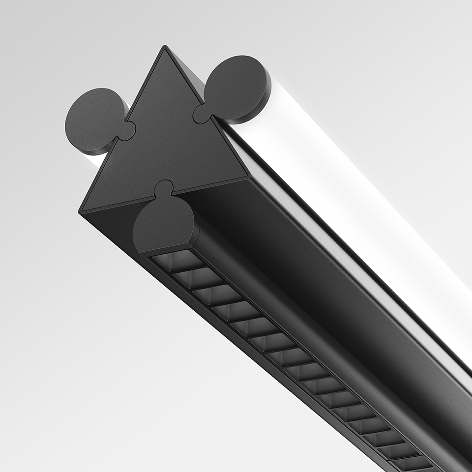 Close-up of Artemide Dreispitz linear light fixture in black, featuring triangular cross-section profile with cylindrical connectors and louvered diffuser