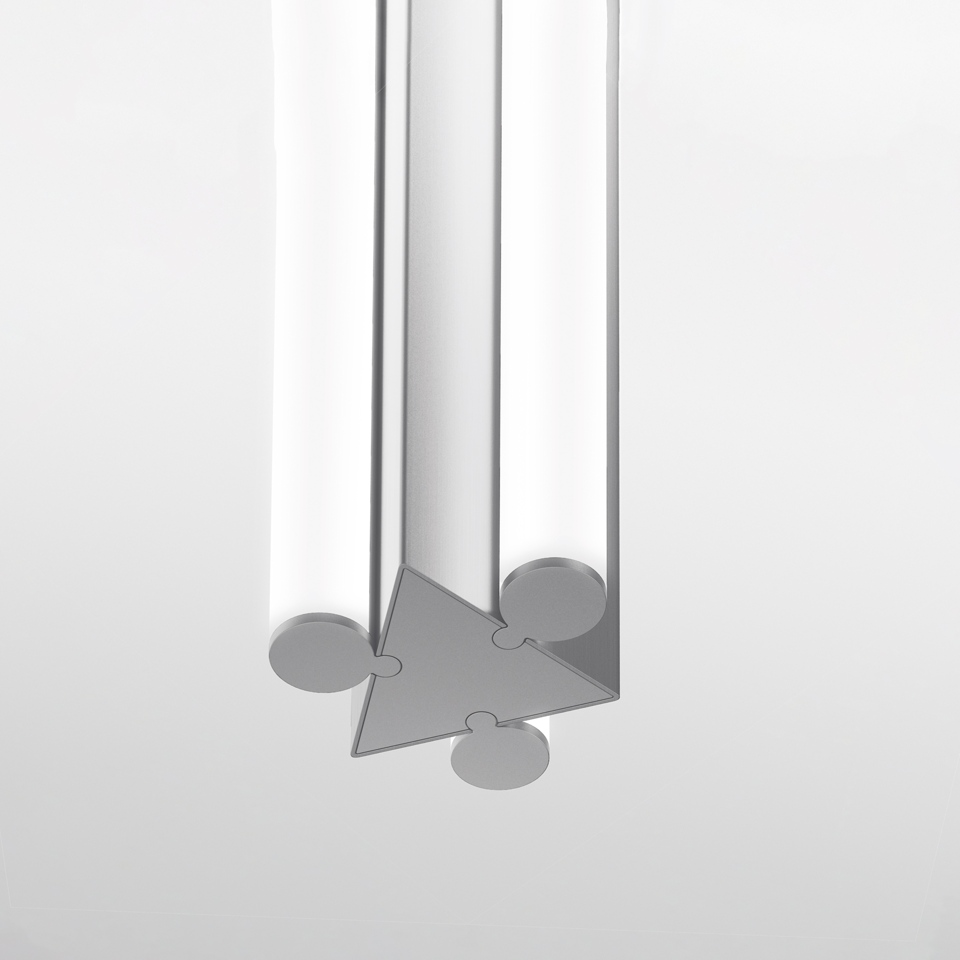Artemide Dreispitz pendant lamp detail: three cylindrical tubes joined by a triangular puzzle-piece connector in brushed aluminum finish