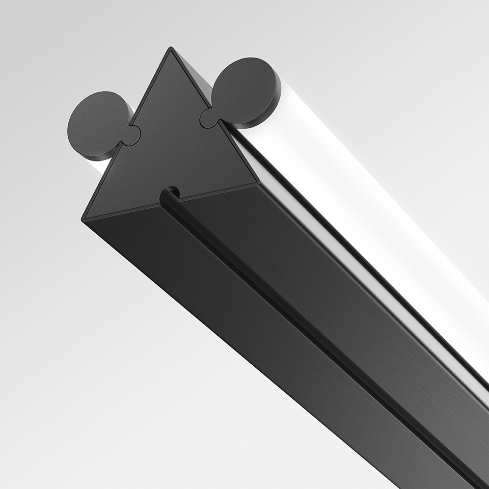 Artemide Dreispitz linear LED fixture detail: black triangular profile with two circular end caps and a frosted diffuser strip