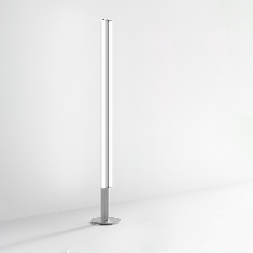 Artemide Dreispitz floor lamp: tall slim cylindrical LED tube on a round metal base, aluminum finish, minimalist design