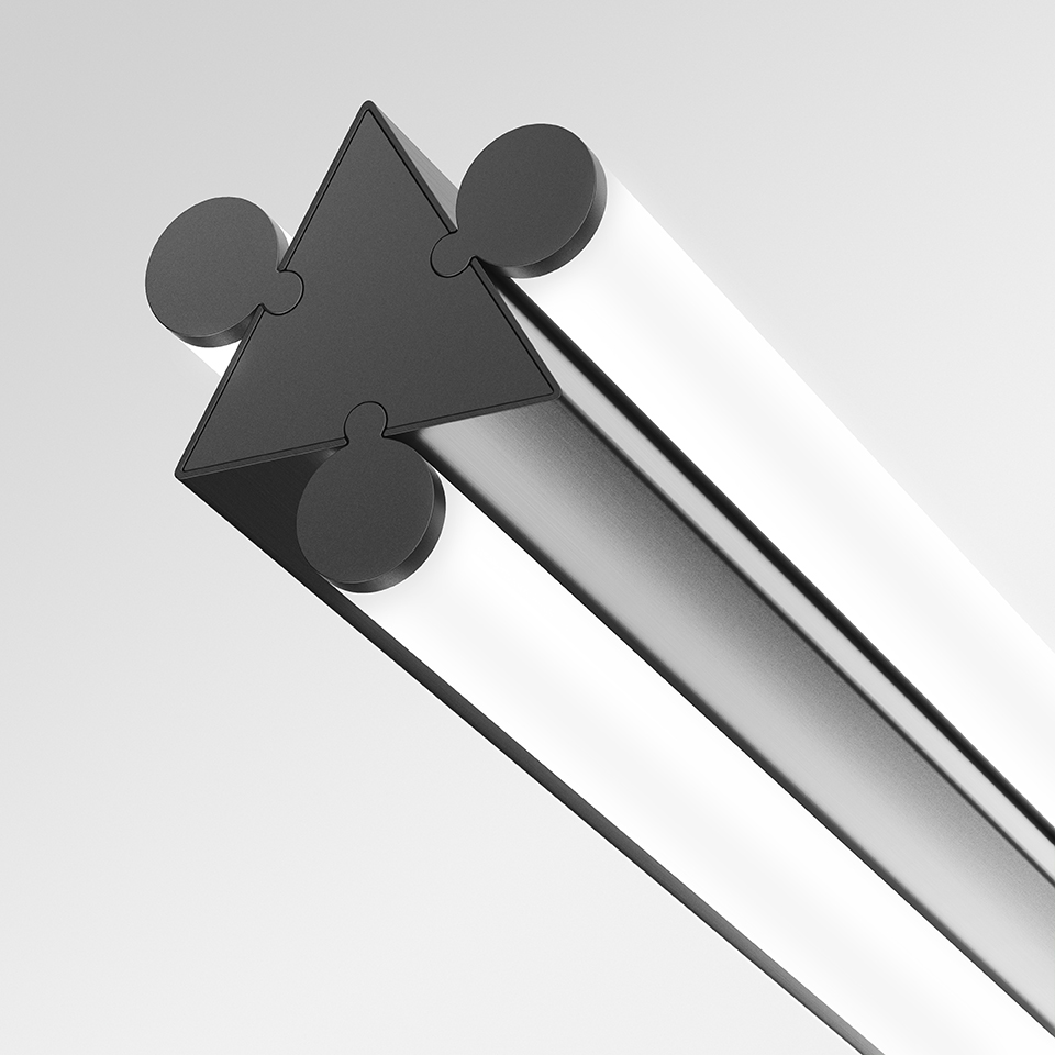 Close-up of Artemide Dreispitz lamp end cap: dark triangular profile with four circular connectors and polished aluminum body