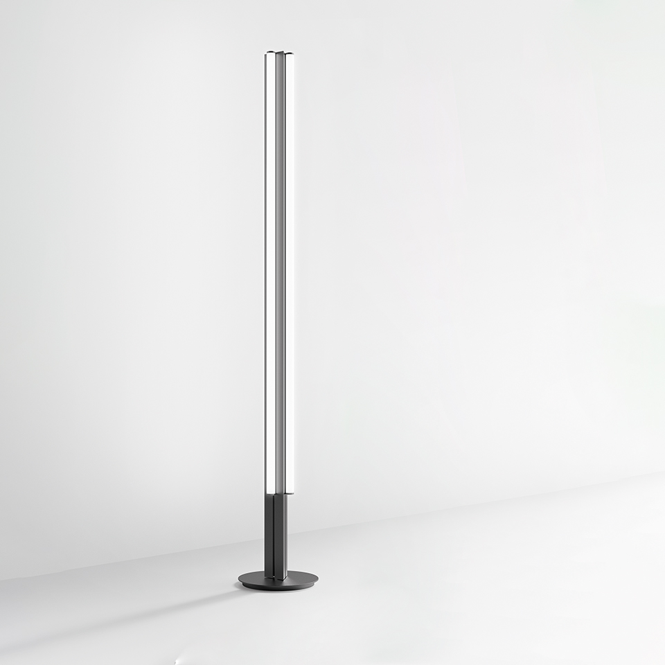 Artemide Dreispitz floor lamp: tall slim cylindrical LED tube on a round dark base, minimalist design