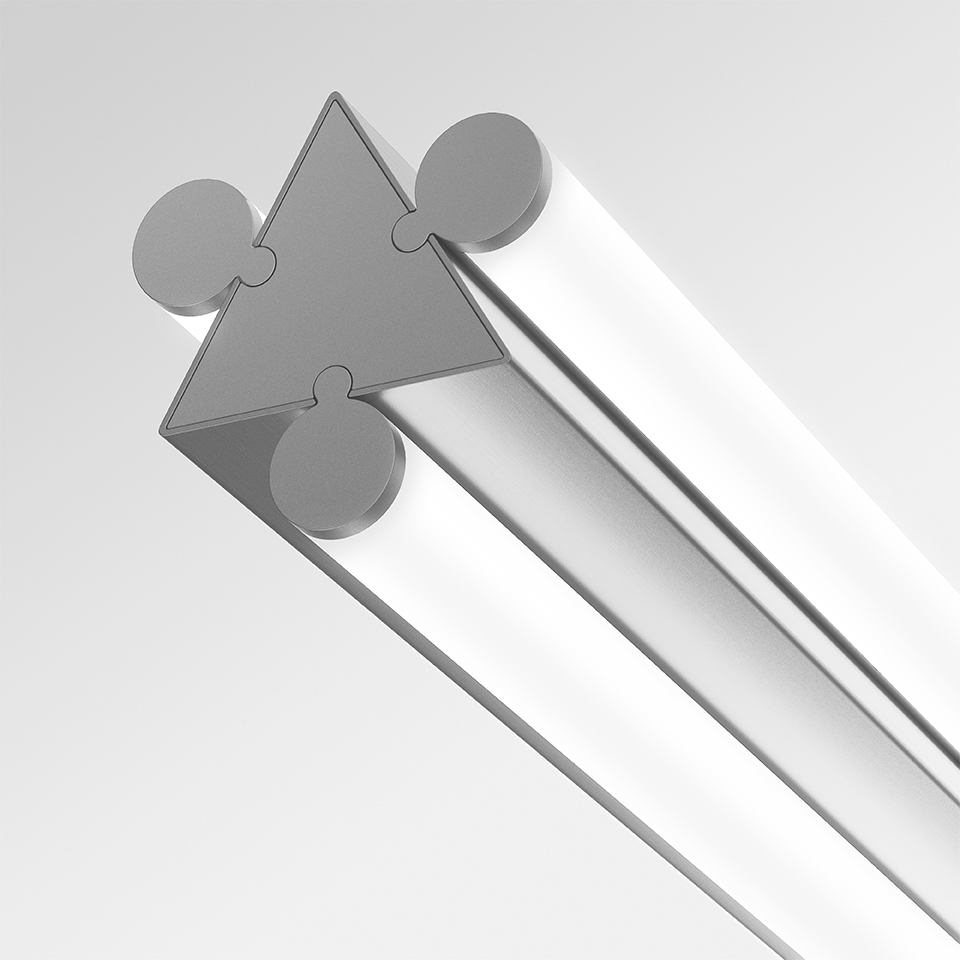 Dreispitz linear LED fixture end cap detail: triangular aluminum profile with modular interlocking connectors and opal diffuser
