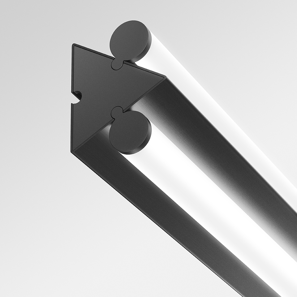 Close-up of Artemide Dreispitz linear light fixture detail: dark triangular connector joining two slim aluminum profiles with LED strips