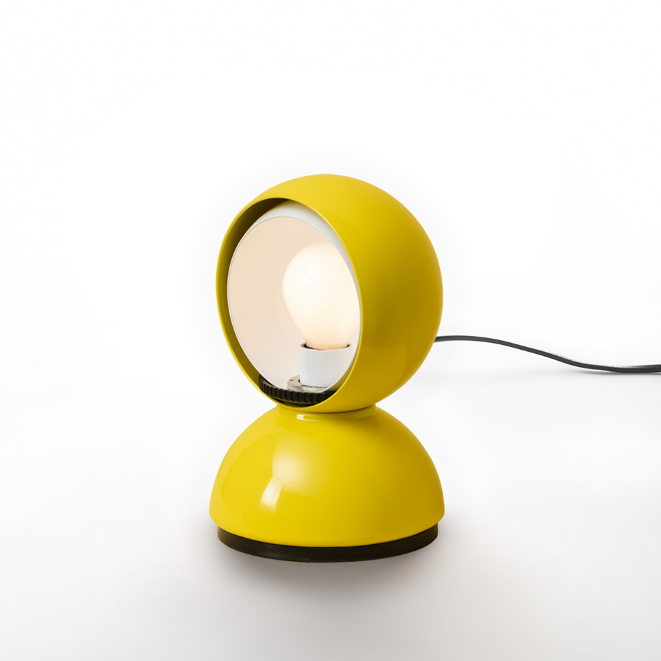 Artemide Eclisse table lamp in yellow, featuring a spherical rotating shade on a dome base, exposing the bulb for adjustable light.
