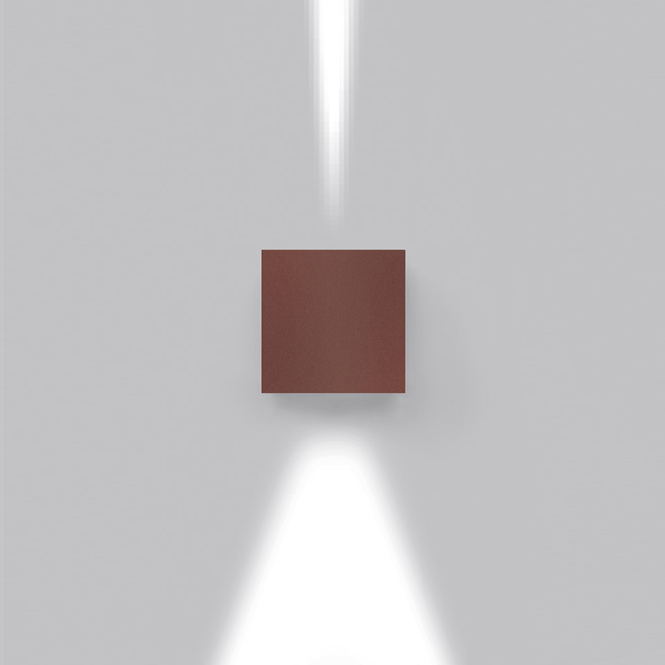 Lampada da parete Effetto in finitura marrone-rosso, con due fasci di luce bianca diretti verso l'alto e il basso su parete grigia