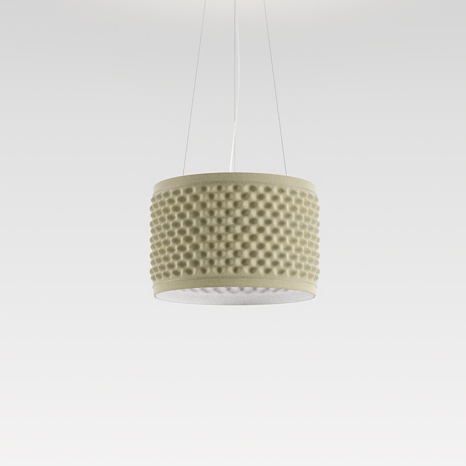 Artemide Eggboard Circle pendant lamp: cylindrical sage-green shade with raised dot texture, suspended by thin cables, diffusing soft light downward