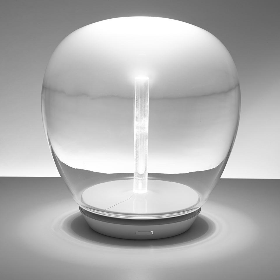 Artemide Empatia table lamp: transparent glass dome enclosing a central LED light column on a round white base