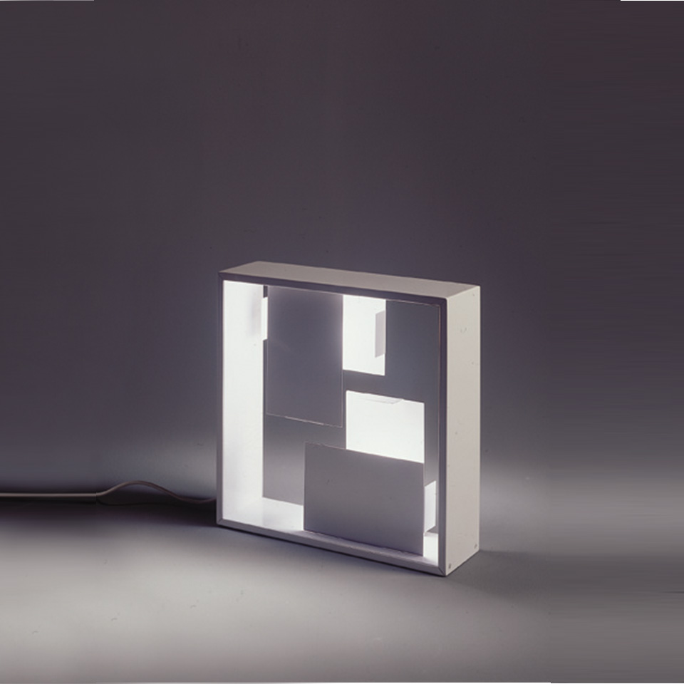 Artemide Fato table lamp: square white frame with internal illuminated panels creating geometric light and shadow composition
