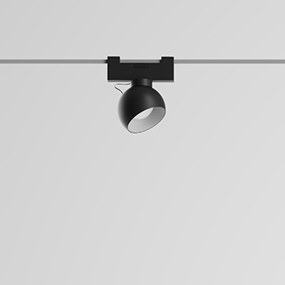 Artemide Funivia track spotlight: black spherical adjustable head mounted on a ceiling track rail system