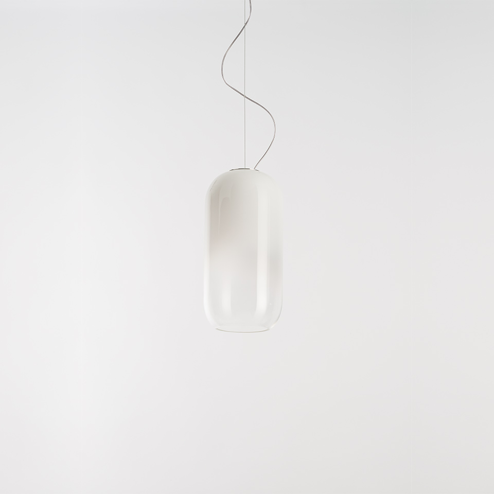 Artemide Gople pendant lamp with elongated capsule-shaped white frosted glass diffuser suspended by a thin cable