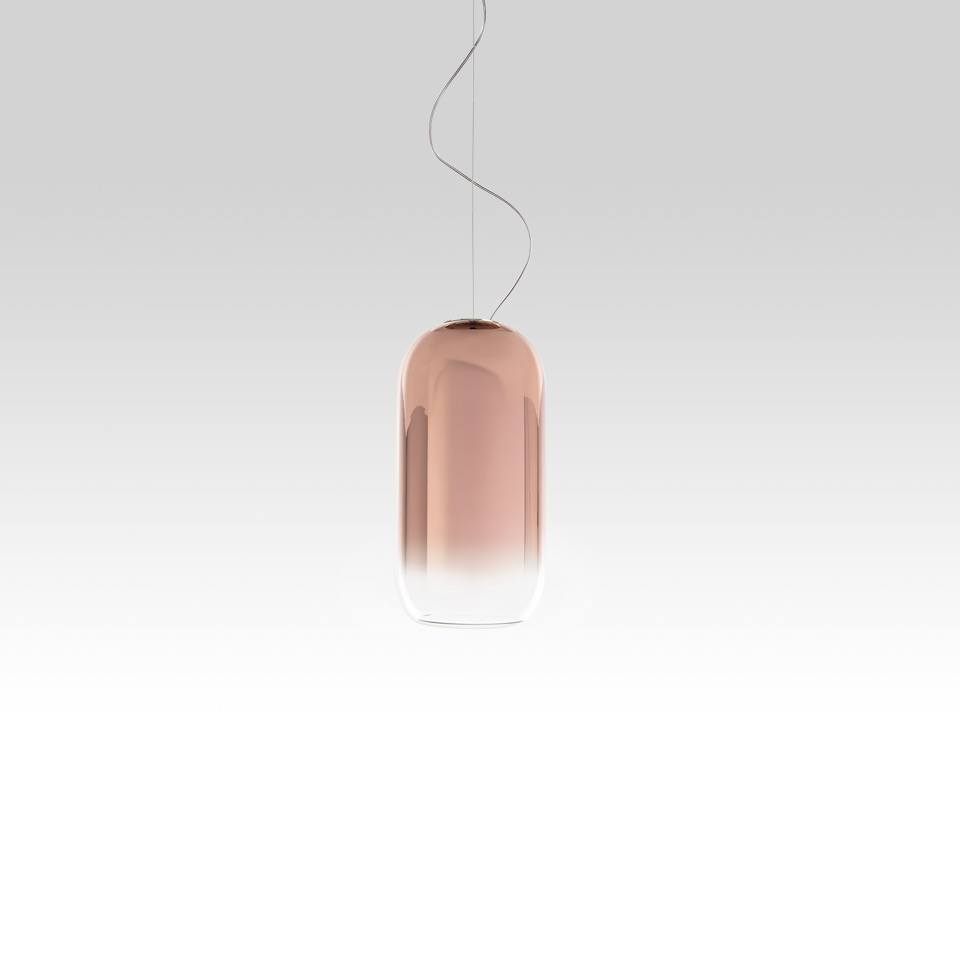 Artemide Gople pendant lamp: pill-shaped blown glass shade with copper-to-clear gradient, suspended by thin steel cable