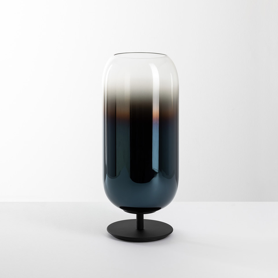 Artemide Gople table lamp: tall capsule-shaped glass shade with blue-to-clear gradient on a round black metal base