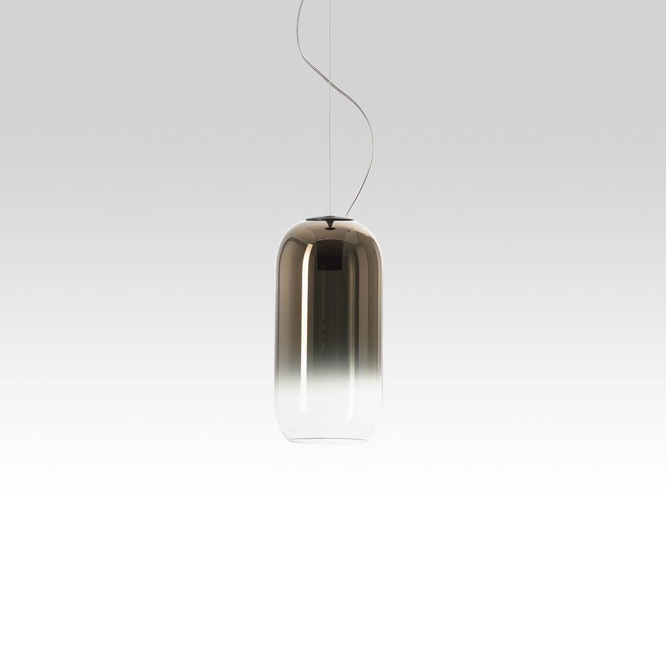 Artemide Gople pendant lamp: cylindrical glass shade with bronze-to-clear gradient, suspended by a thin cable