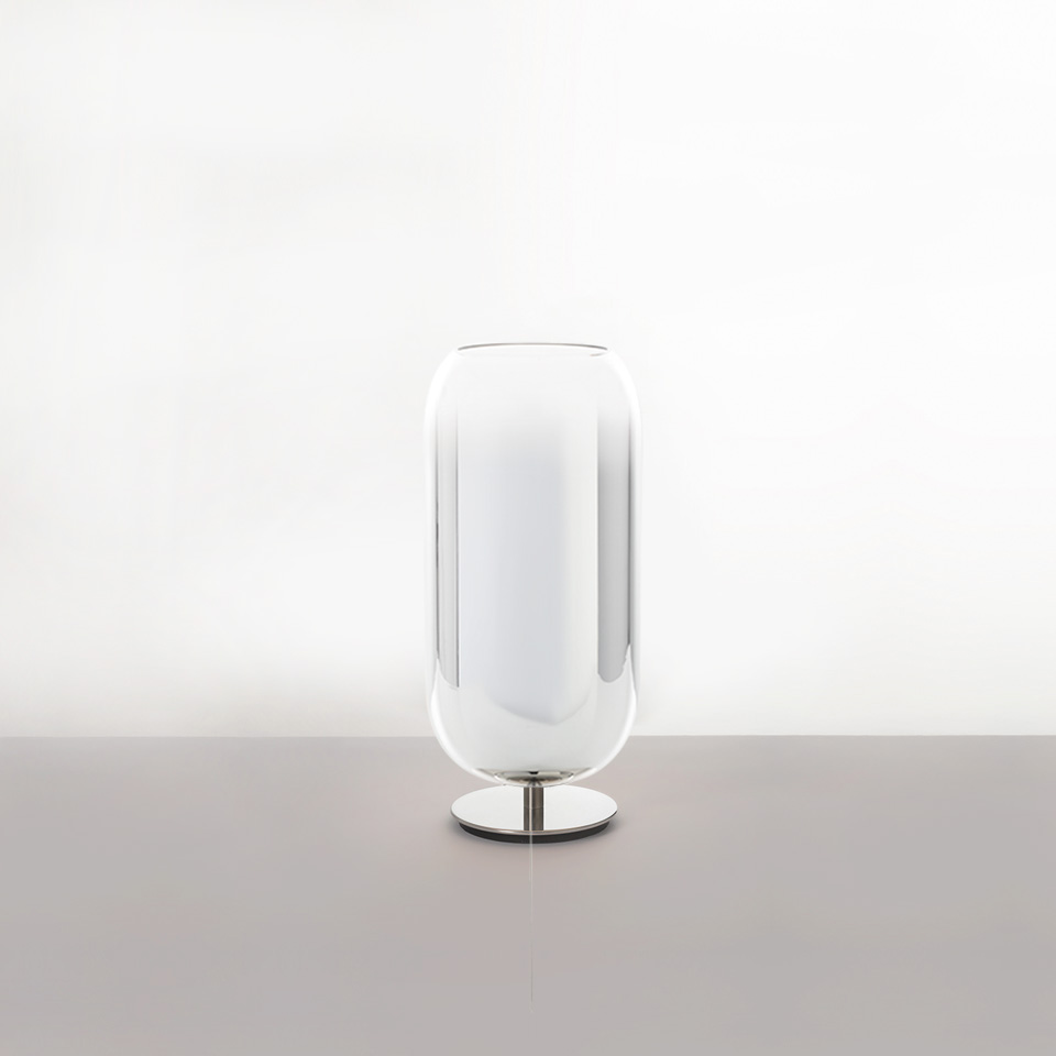 Artemide Gople table lamp with transparent glass diffuser encasing a white inner shell, on a polished chrome base